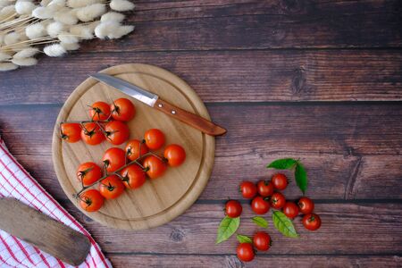 Tomatoes on the wooden floor in the kitchenの写真素材