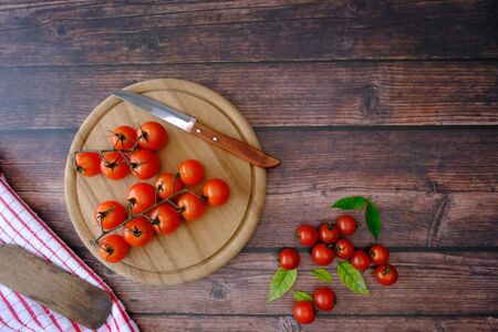 Tomatoes on the wooden floor in the kitchenの写真素材