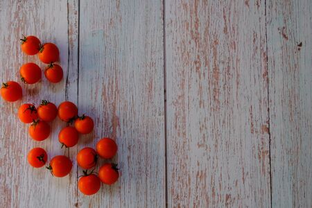 Tomatoes on the wooden floor in the kitchenの写真素材