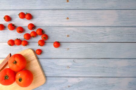 Tomatoes on the wooden floor in the kitchenの写真素材