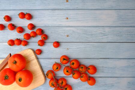 Tomatoes on the wooden floor in the kitchenの写真素材