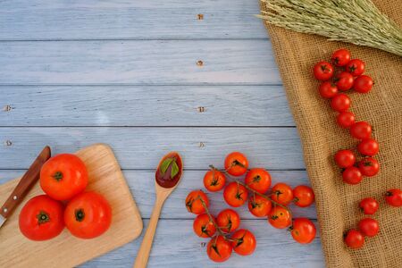 Tomatoes on the wooden floor in the kitchenの写真素材