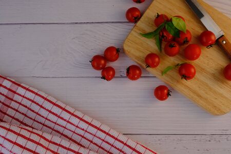 Tomatoes on the wooden floor in the kitchenの写真素材