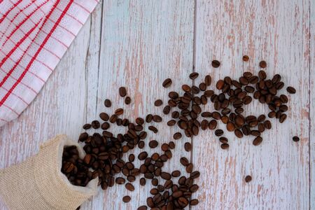 Coffee beans on the wood floorの写真素材