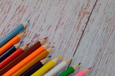 Colored pencils on the wood floorの写真素材