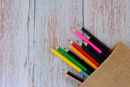 Colored pencils on the wood floorの写真素材