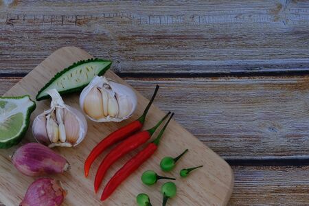 Chili, onion, garlic on the wooden floor in the kitchenの写真素材