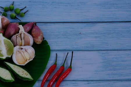 Chili, onion, garlic on the wooden floor in the kitchenの写真素材