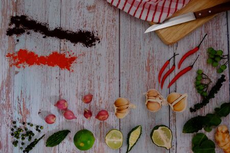 Peppers, onions, garlic and spices on the wood floor in the kitchenの写真素材