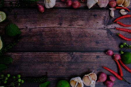 Peppers, onions, garlic and spices on the wood floor in the kitchenの写真素材