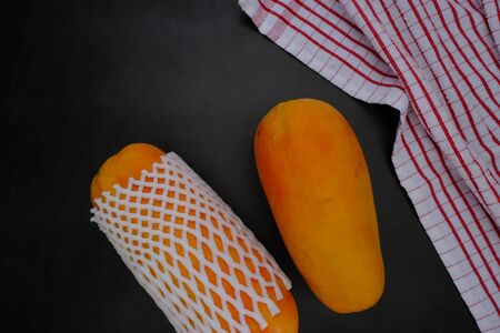 Papaya on the black background in the kitchenの写真素材