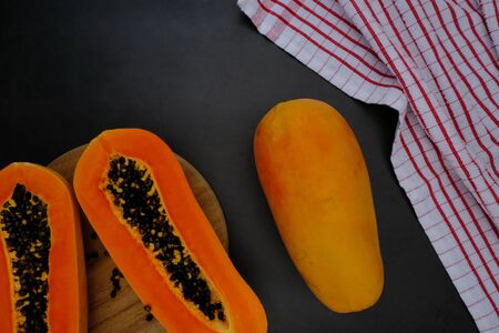 Papaya on the black background in the kitchenの写真素材