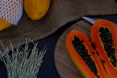 Papaya on the black background in the kitchen