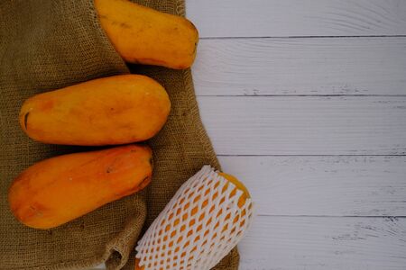 Papaya on the wooden floor in the kitchenの写真素材