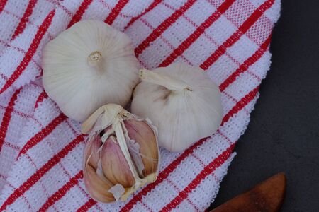 White garlic on the wooden floor in the kitchenの写真素材
