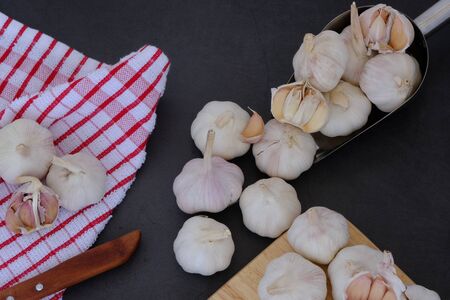 White garlic on the wooden floor in the kitchenの写真素材