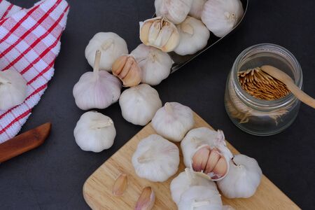 White garlic on the wooden floor in the kitchenの写真素材