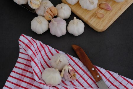 White garlic on the wooden floor in the kitchenの写真素材