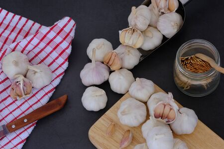 White garlic on the wooden floor in the kitchenの写真素材