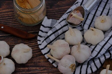White garlic on the wooden floor in the kitchen for cookingの写真素材