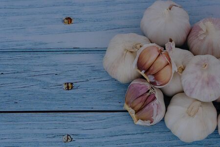 White garlic on the wooden floor in the kitchenの写真素材