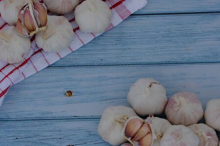 White garlic on the wooden floor in the kitchenの写真素材