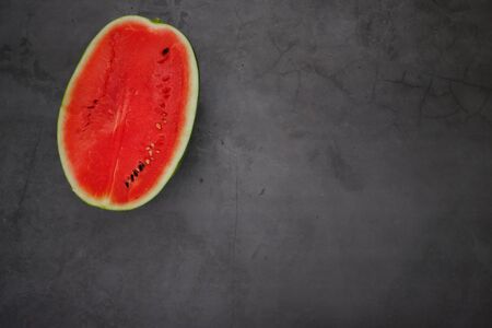 Bright red watermelon from the farm in the kitchenの写真素材