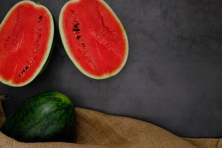 Bright red watermelon from the farm in the kitchenの写真素材