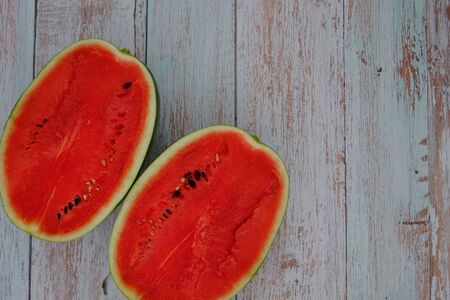 Red watermelon on the wooden floor in the kitchenの写真素材
