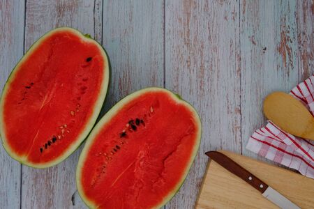 Red watermelon on the wooden floor in the kitchenの写真素材