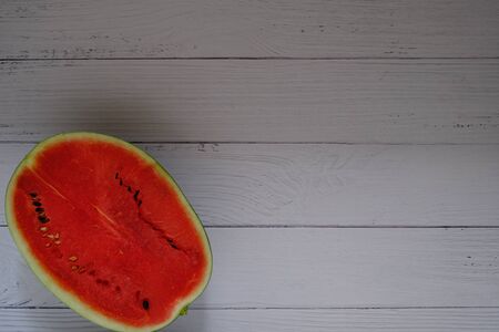 Red watermelon on the wooden floor in the kitchenの写真素材