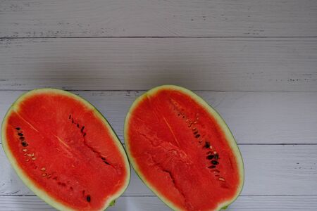 Red watermelon on the wooden floor in the kitchenの写真素材