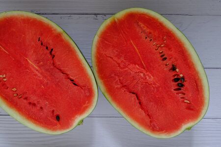 Red watermelon on the wooden floor in the kitchenの写真素材