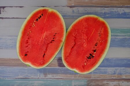 Red watermelon on the wooden floor in the kitchenの写真素材