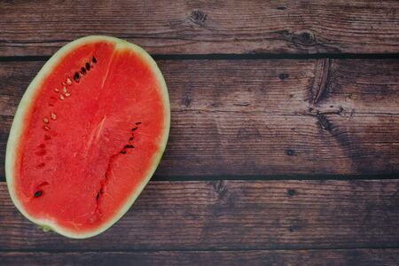 Red watermelon on the wooden floor in the kitchenの写真素材