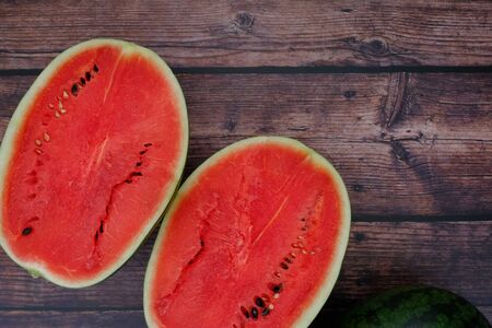 Red watermelon on the wooden floor in the kitchenの写真素材