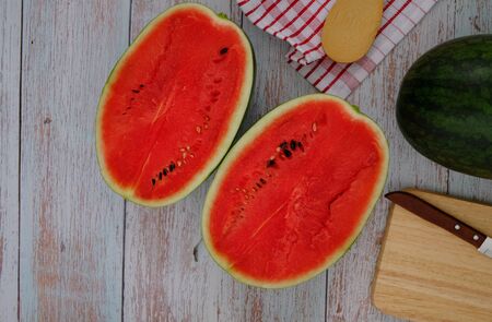 Red watermelon on the wooden floor in the kitchenの写真素材