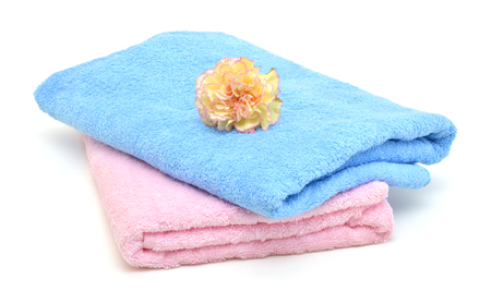 colorful towels and carnation flower isolated on whiteの写真素材