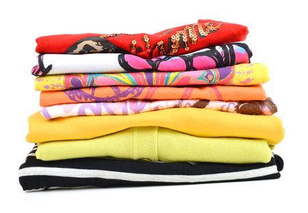 Pile of coloured clothes from the laundry - isolated on whiteの写真素材