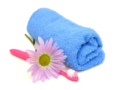 Close up of a toothbrush and towel on white backgroundの写真素材