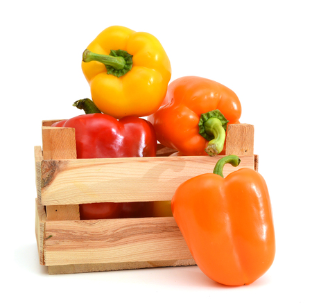 colorful mix of paprika's(capsicum) in a wooden box on a white backgroundの写真素材