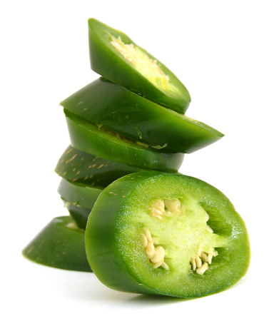 A pile of finely chopped chilli peppers on a white backgroundの写真素材