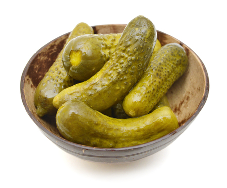 wood bowl with marinated cucumbers on the whiteの写真素材