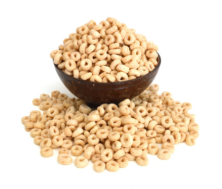 healthy cereal rings in wooden bowl on whiteの写真素材