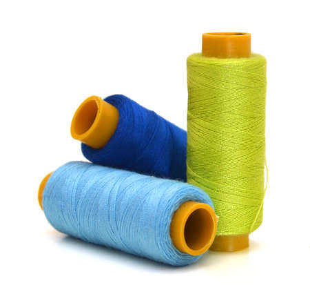 Spool of coloured thread isolated on white background.