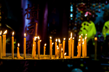 a row of candle at the buddhism temple