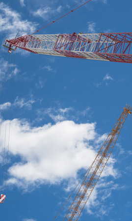 Industrial construction crane against blue sky backgroundの写真素材
