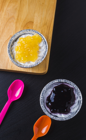 Small peach and blueberry pies on wooden blockの写真素材