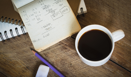 Business or education concept, Scrap paper place beside coffee cup and pencil on wooden table
