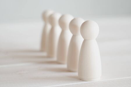 row of wooden dolls on the tableの写真素材